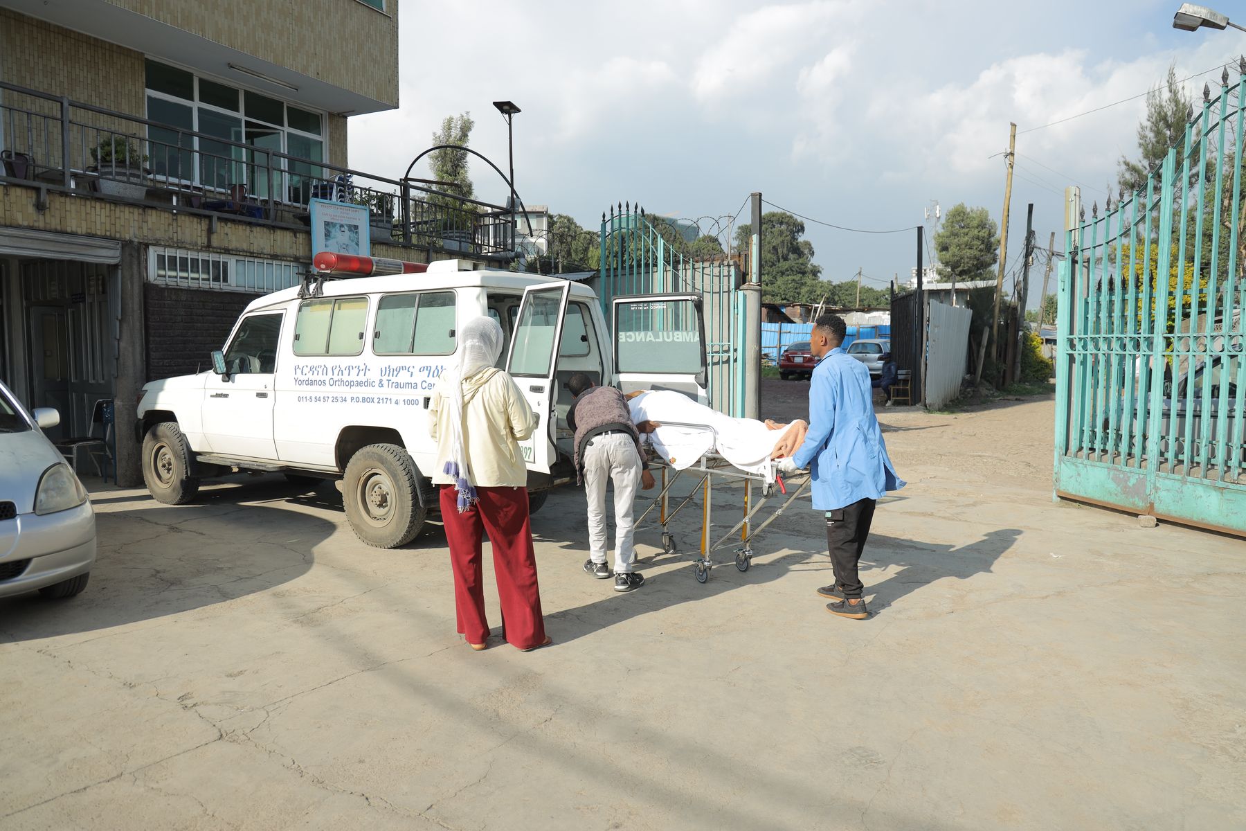 A patient being wheeled from the Yordanos Hospital ambulance into emergency care