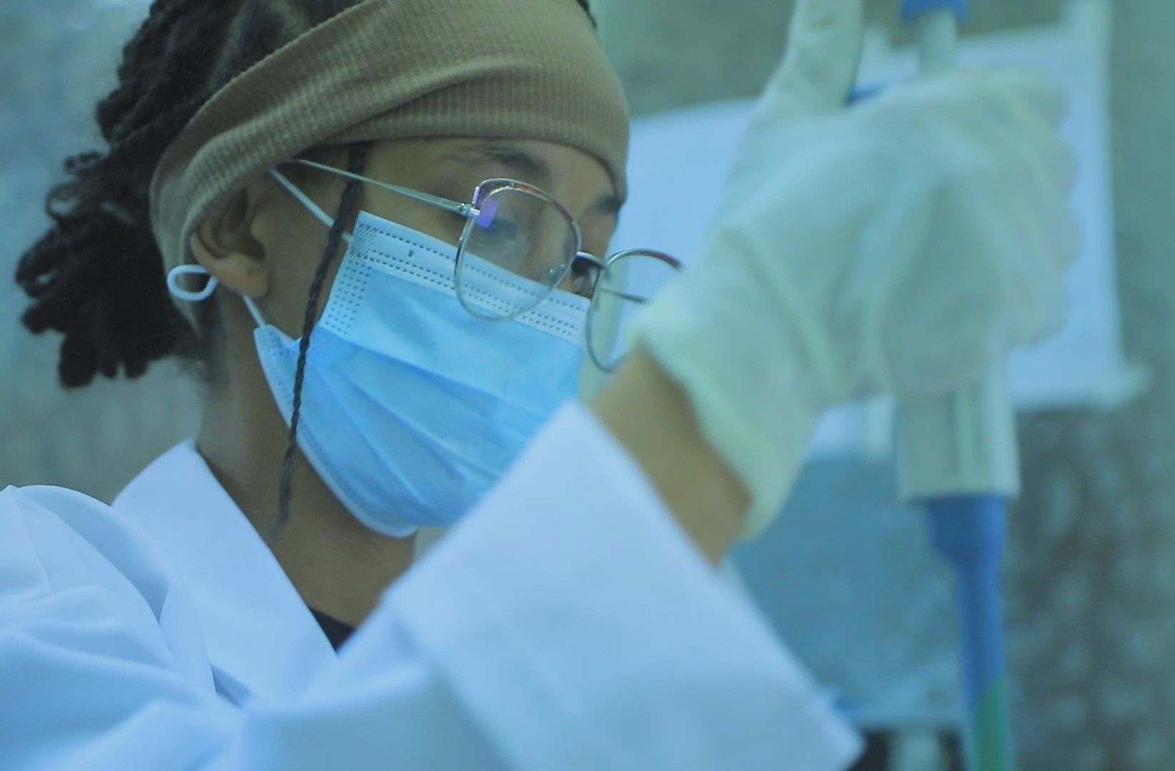 A laboratory technician working with a pipette