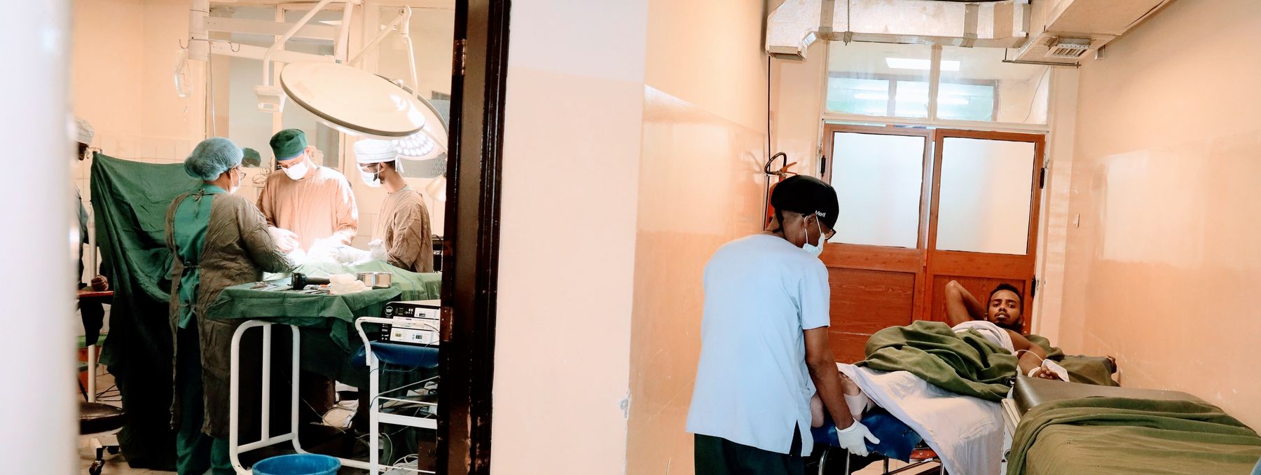 The operating theatre and a patient being prepared outside it