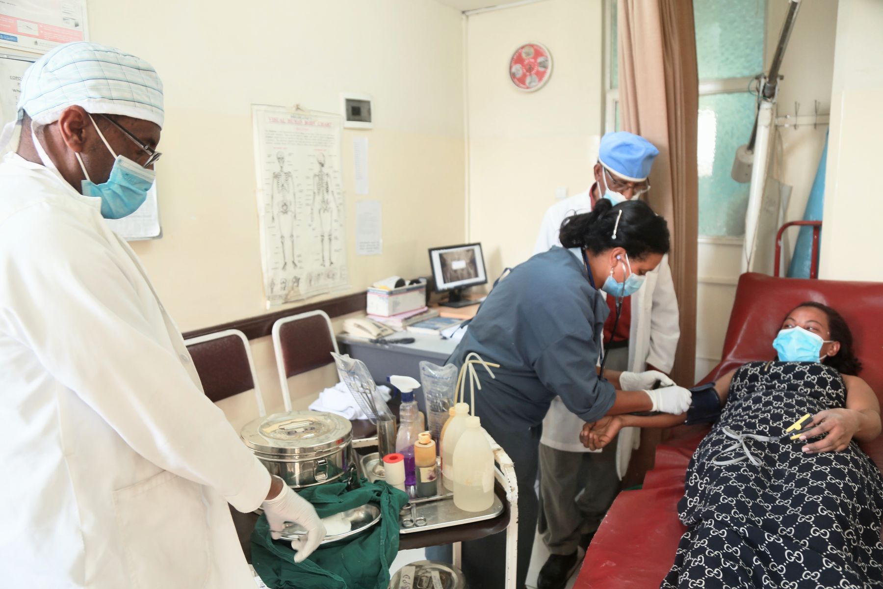 Staff preparing a patient for treatment in the treatment room