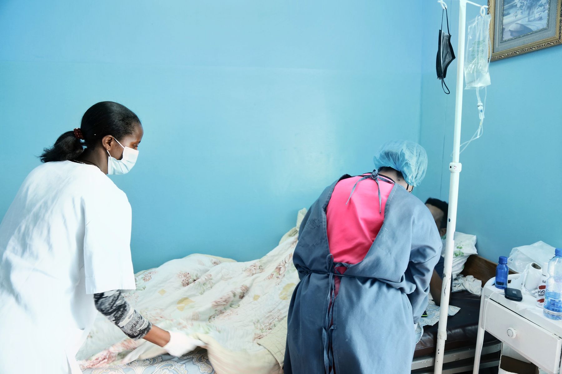 Nurses caring for a patient on the ward