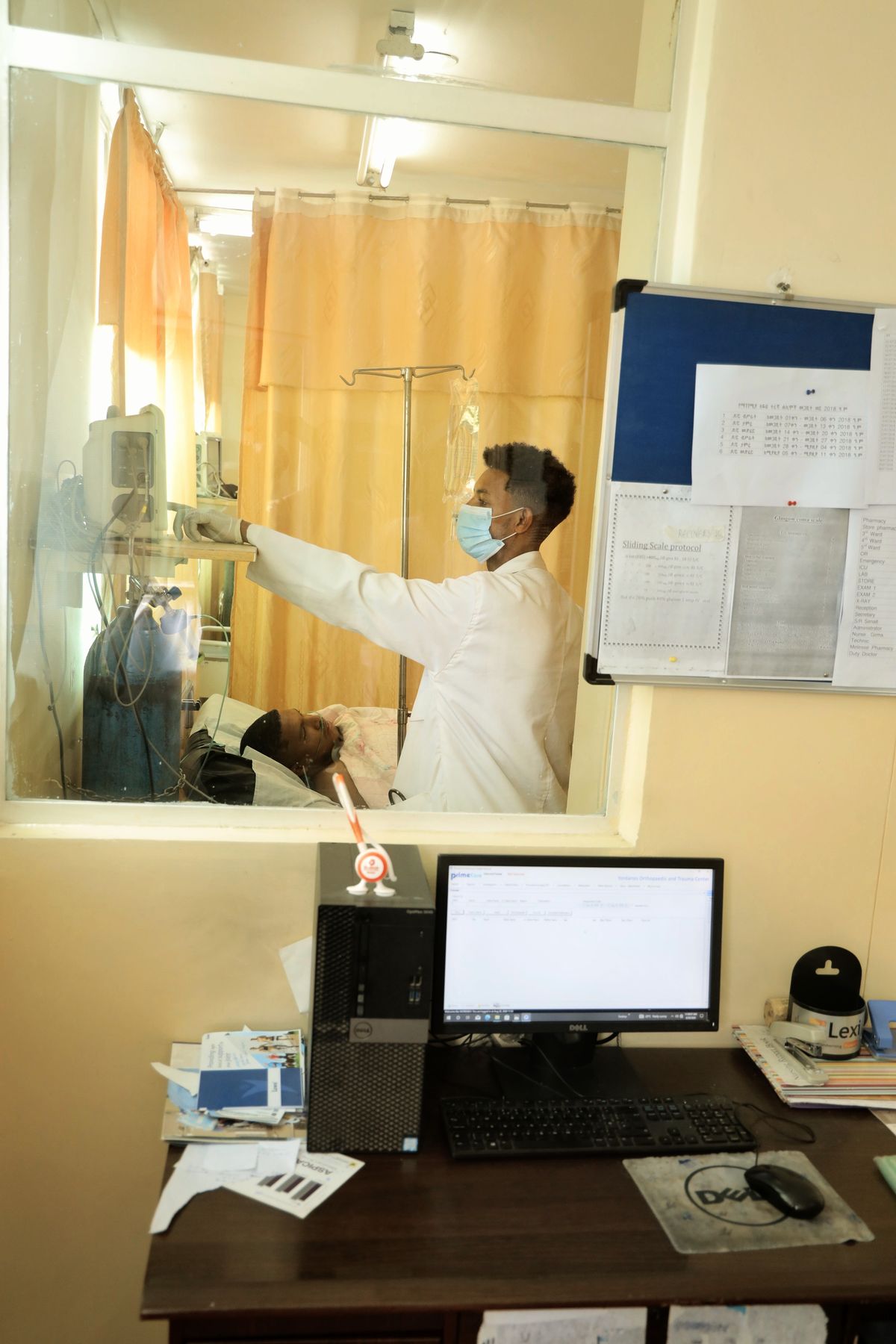 A nurse checking equipment at a ward station
