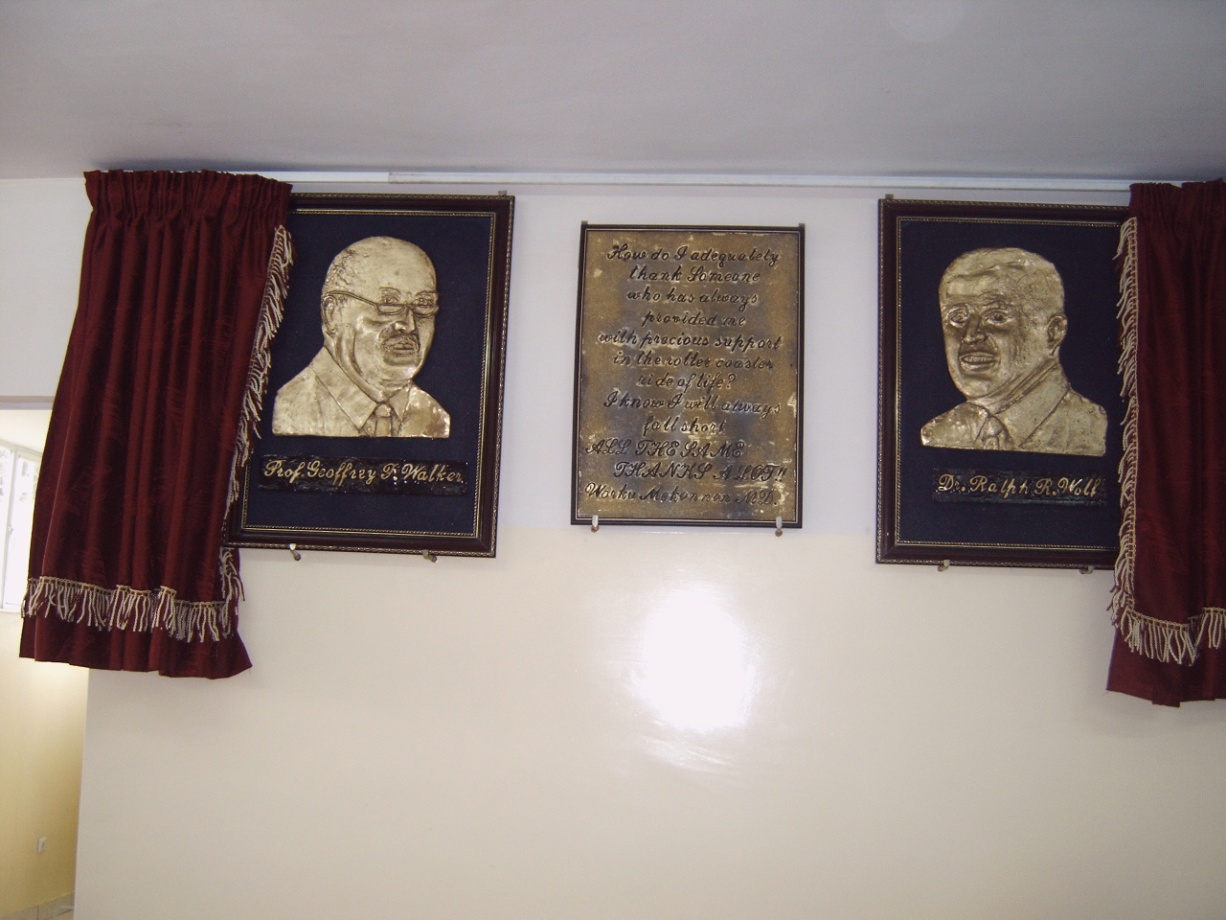 Bronze tribute plaques at Yordanos Hospital honoring Prof. Geoffrey Walker and Dr. Ralph R. Wolf