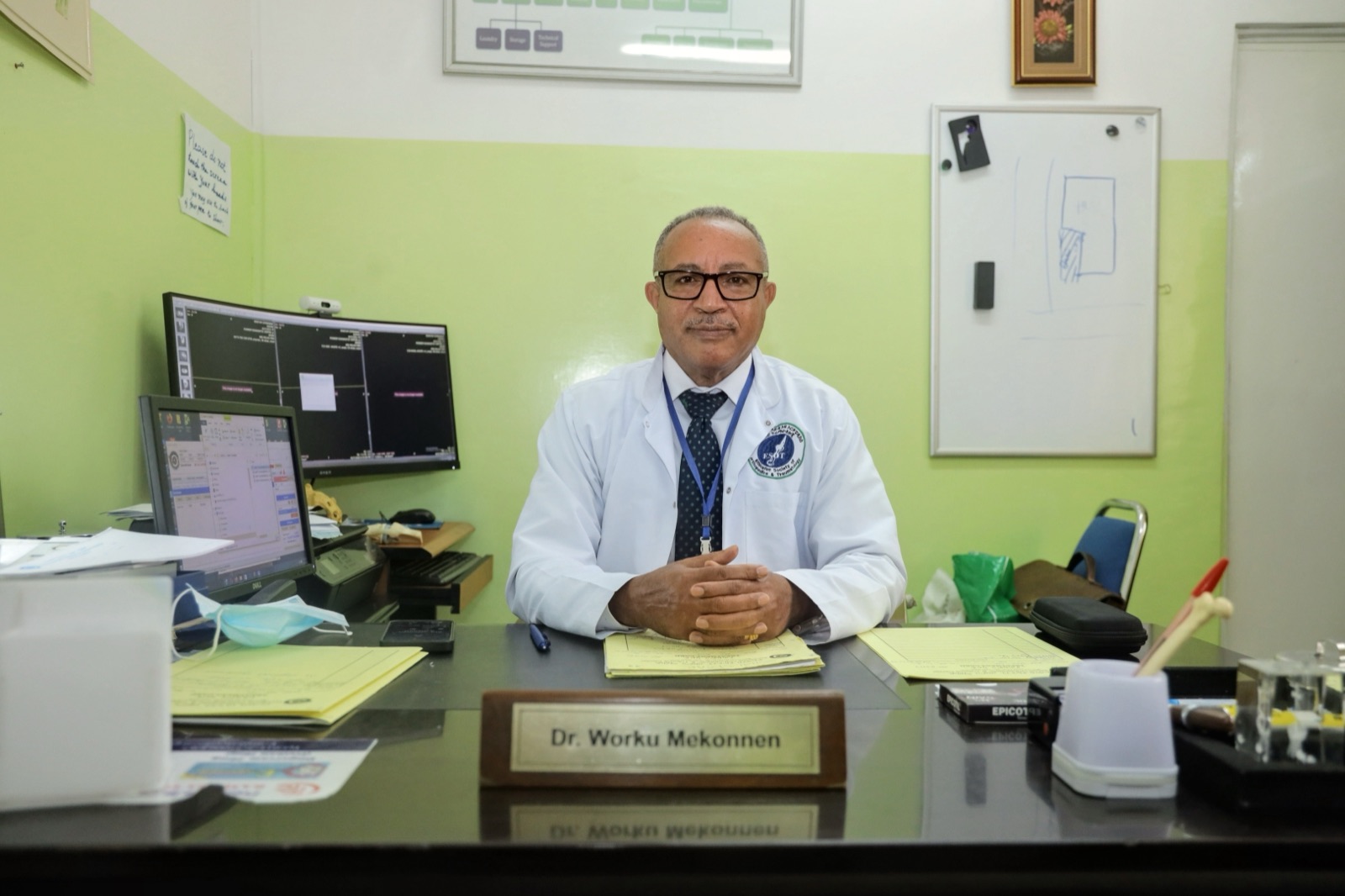 Dr. Worku Mekonnen, Founder and Consultant Orthopedic Surgeon, at his desk at Yordanos Hospital