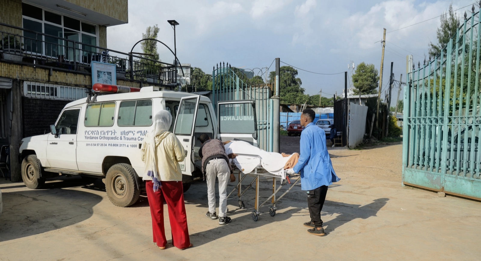 A patient being wheeled from the Yordanos Hospital ambulance into emergency care