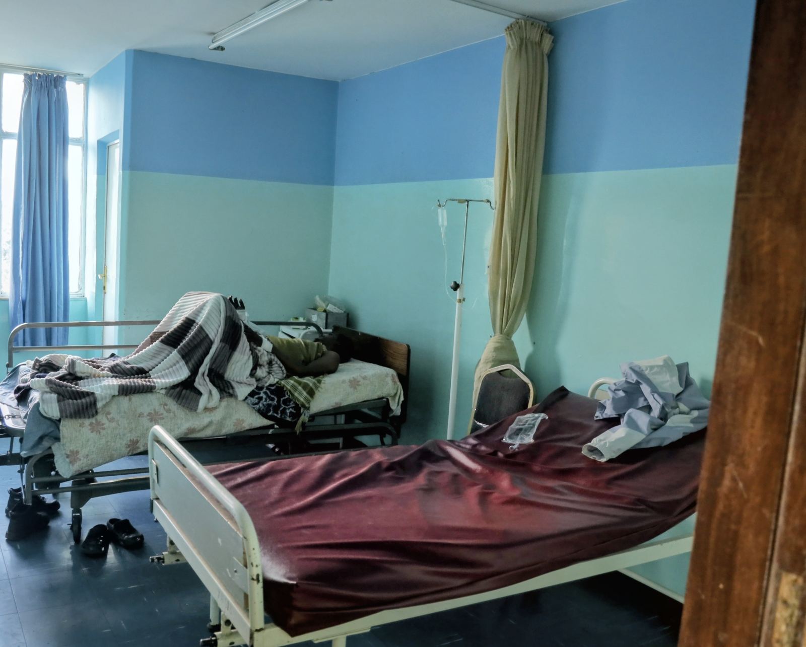 An inpatient ward at Yordanos Hospital with beds and large windows